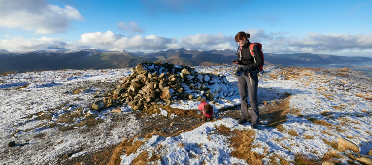 Woman and dog on wintery hill