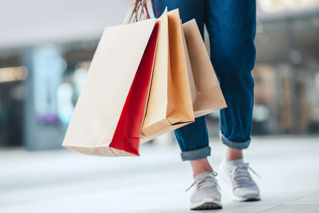 Woman holding shopping bags in the street