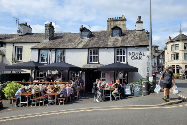 An external shot of the white exterior and beer garden at The Royal Oak in Ambleside