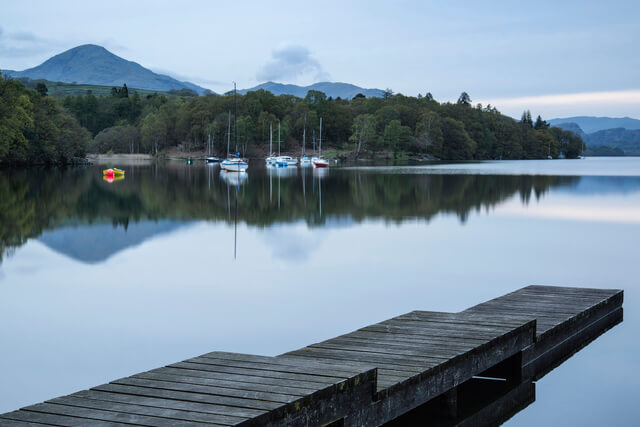 A view of boats on Coniston Water as the sun goes down