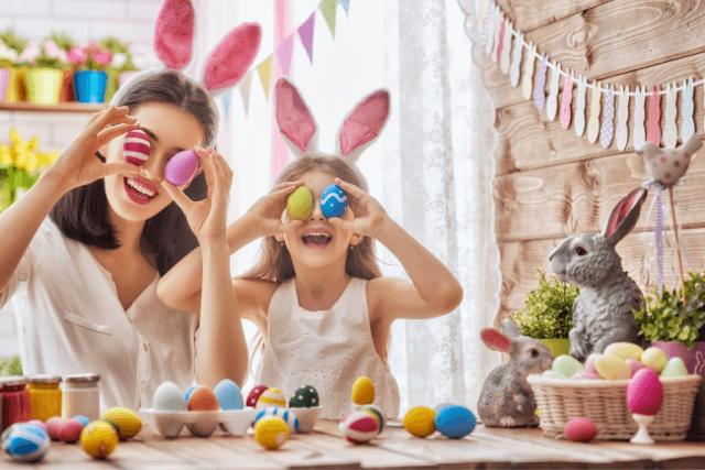 A mum and daughter painting easter eggs.