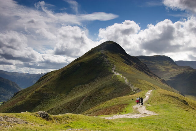 A group of people on the walking trail leading to the summit of Catbells