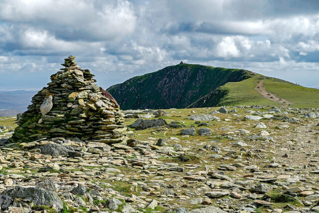 A pile of rocks marking the summit trig point on The Old Man of Coniston