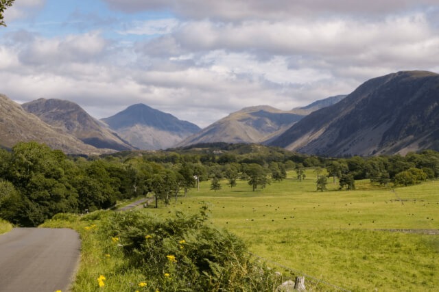 Looking down a valley towards mountains in the background in the Lake District
