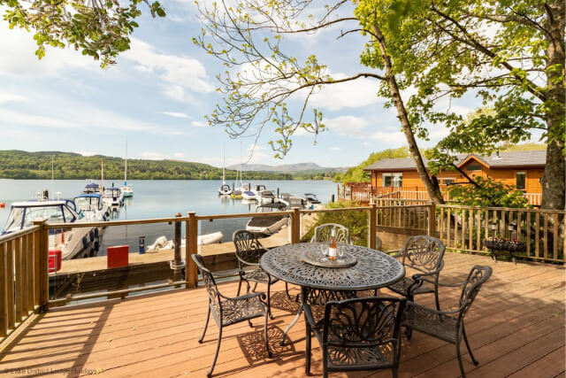 Looking over a lake in the Lake District from a wooden deck